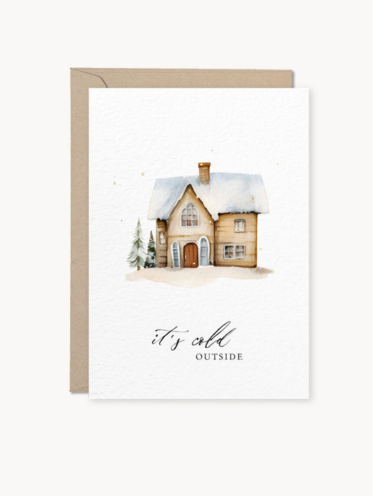 Grußkarte mit Winterhaus-Motiv und Schriftzug „it's cold outside“ auf hellem Naturkarton, inklusive Kraftpapier-Umschlag